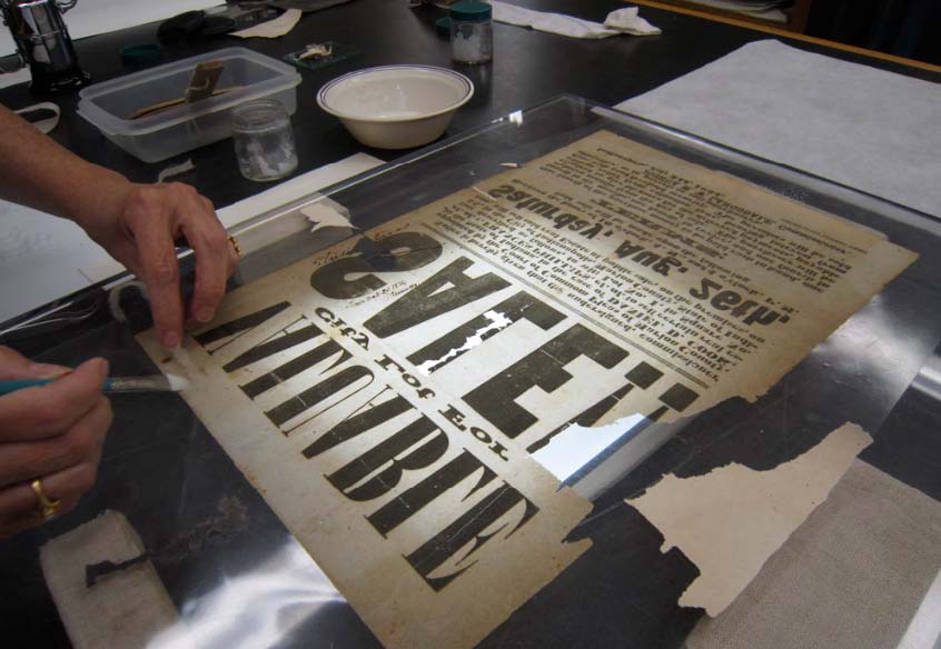 Paper was cut to fit losses and inserted with wheat starch paste while broadside was on a light table.