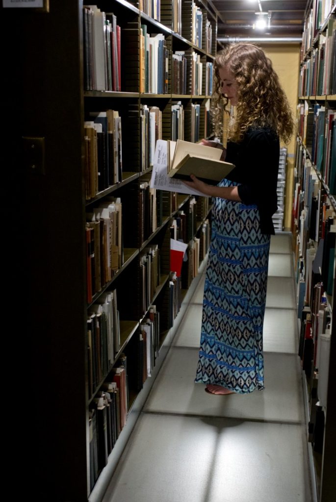 Claire Jones, summer intern from Princeton, paging a book in the American Antiquarian Society stacks.